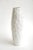 This tall Italian vintage textural white ceramic vase or vessel has sculptural presence to it. It is from the 80's. It has...