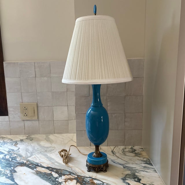 Vintage French style blue porcelain table lamp with an ornate, filigree base. The base of the lamp measures 4.75x4.75.”...