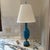 Vintage French style blue porcelain table lamp with an ornate, filigree base. The base of the lamp measures 4.75x4.75.”...