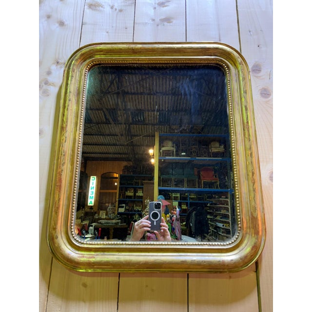 A louis xvi style wall mirror in stuccoed wood, gilded with gold leaf, dating from the second quarter of the 19th century....
