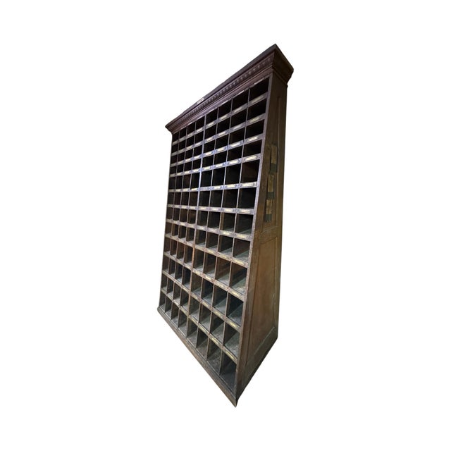 This monumental industrial storage cabinet reflects exceptional early American craftsmanship and utility. It bears both...