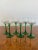 Set of six quality Edwardian wine glasses with green stems on a circular base