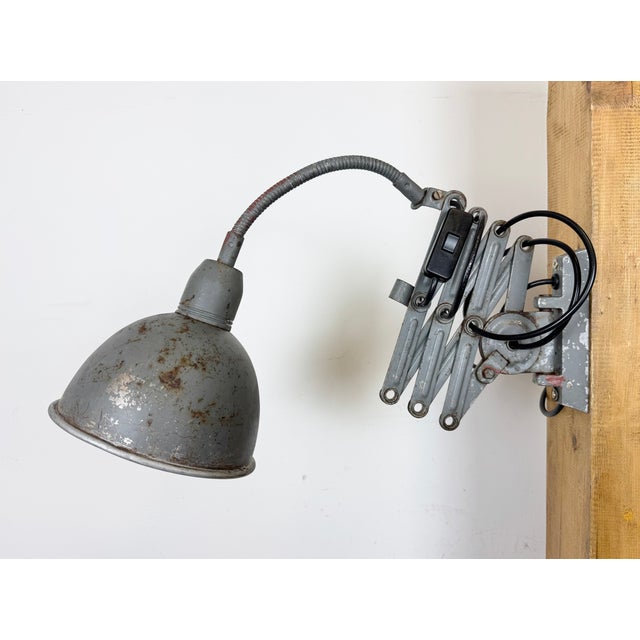 This vintage industrial adjustable gooseneck grey scissor wall light was produced by Elektroinstala Dečín in former...