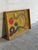 This striking canvas painting features an expressive abstract composition with vibrant yellow tones and bold shapes....