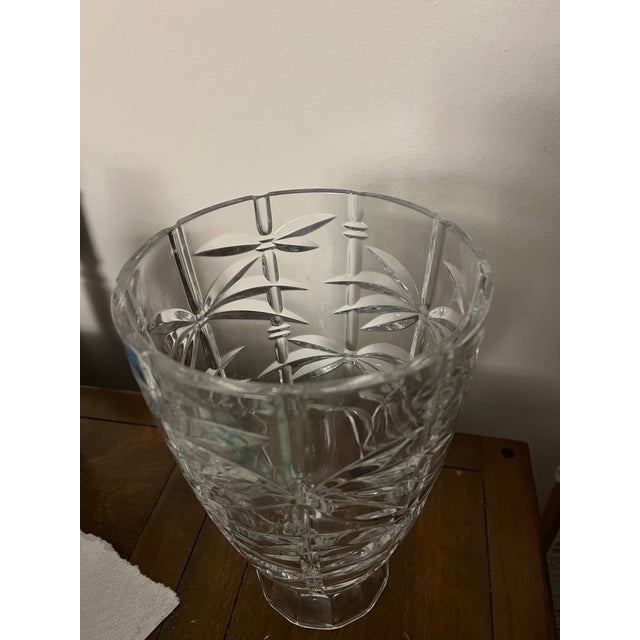 Great vase for a bouquet of flowers. Clear crystal glass with designs that look like bamboo shoots. Heavy thick crystal...
