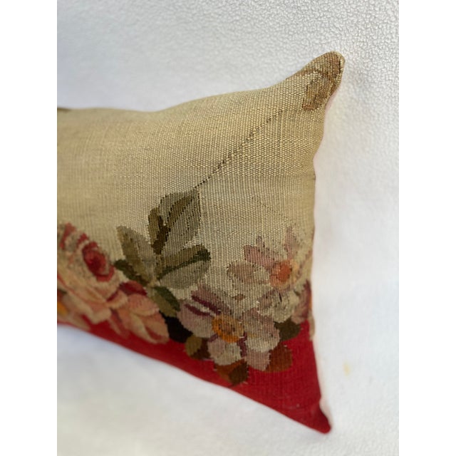 Decorative pillow upholstered in richly woven 19th century Aubusson tapestry, adorned with an elegant floral motif. A...