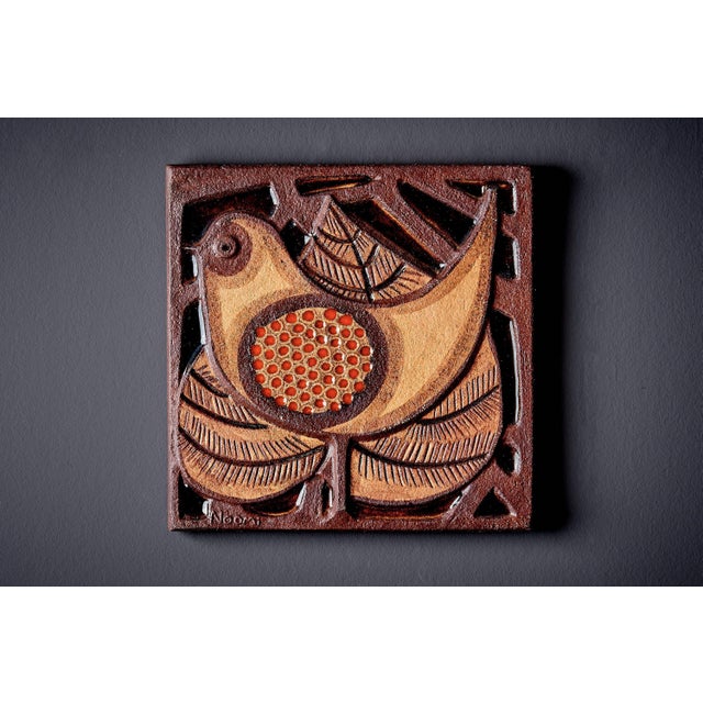 Rare ceramic wall mural designed by Noomi Backhausen for Søholm, with a raised bird motif in warm brown and ochre glazes....
