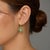 Elegant 14K yellow gold drop dangle earrings featuring green amethysts, tsavorites, and brilliant round diamonds in a...