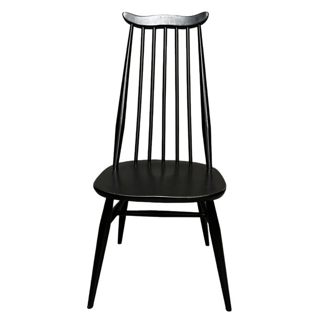 This set of four Black Goldsmith Ercol dining chairs is crafted from solid elm, offering both durability and timeless...