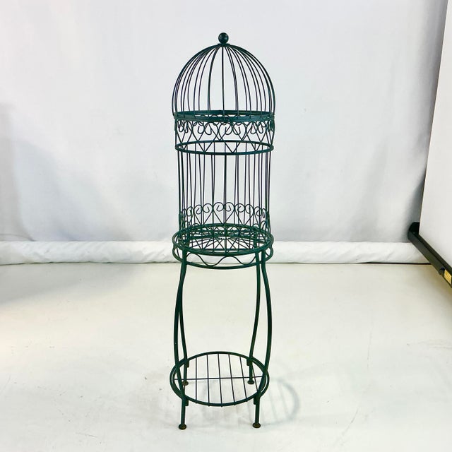 This is a very well designed Birdcage Plant Stand. It consists of a metal base with a Lower Tier that can hold a potted...