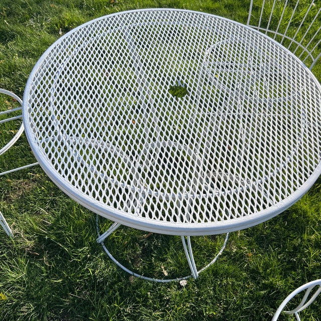 This item is a vintage mid-century modern wire patio chair set and table manufactured by Homecrest, likely from the 1960s....