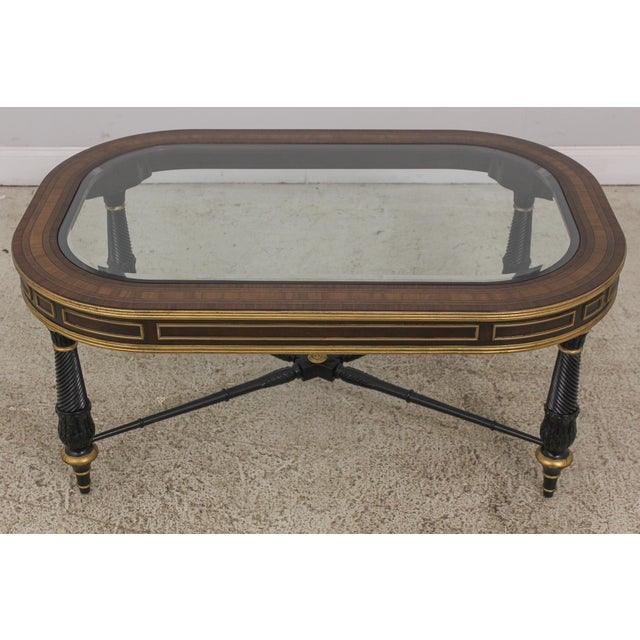 Pre-owned EJ Victor glass-top cocktail table crafted from mahogany solids with inlays. Features an ebony and dark walnut...