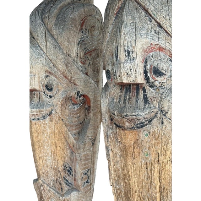 Mounted on custom black-painted metal stands, this striking pair of antique Singa sculptures originates from the Batak...