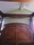 This is a burled oak veneer and solid wood with mahogany stain king size canopy bed from the American Signature West...