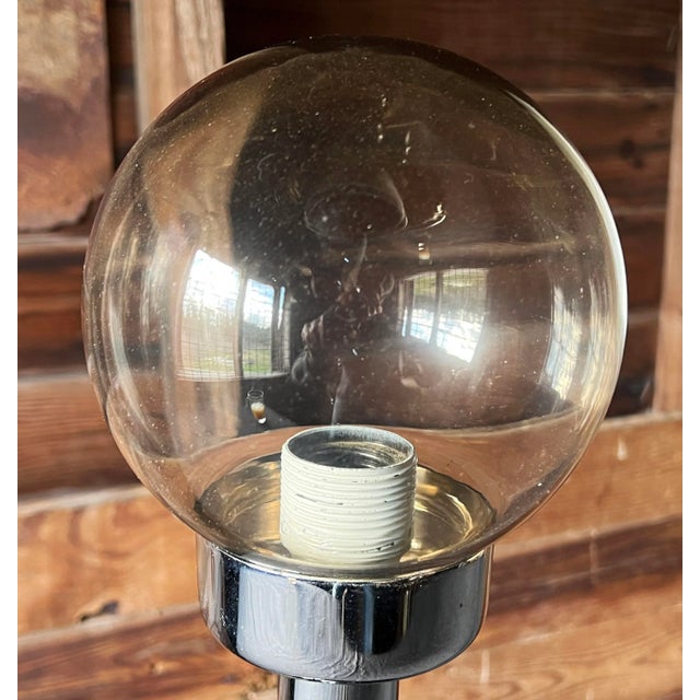 Vintage c.1970's chrome table lamp with a smoked glass globe by the French design firm S.C.E. It has a great weight and...