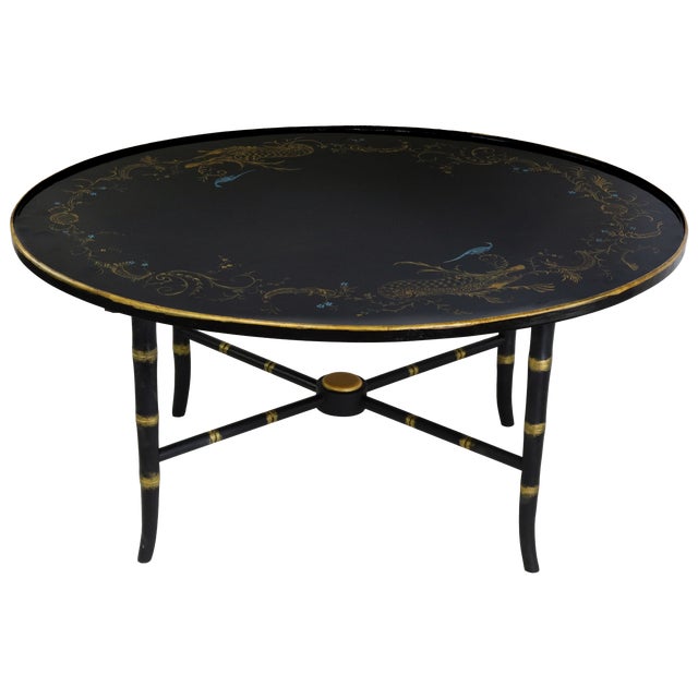 This pair of stunning vintage coffee tables feature a sophisticated black lacquer finish adorned with an intricate...