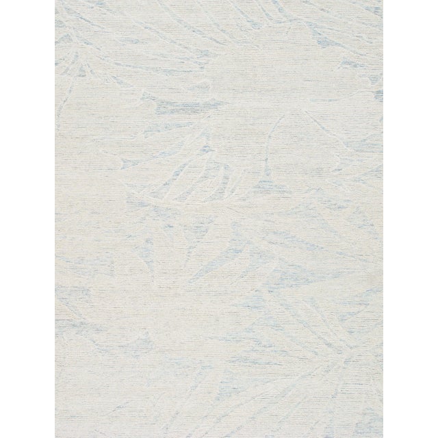 Bring a fresh, relaxed feel to your space with this beautiful hand-tufted rug featuring an elegant palm leaf design in...