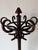 Classic antique Thonet-style bentwood hall tree featuring elegantly curved hooks and a sculptural circular crown, crafted...