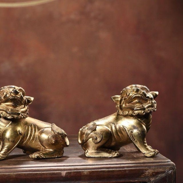 This charming pair of gilt bronze guardian lions adds a touch of traditional elegance to any space. Each lion is finely...