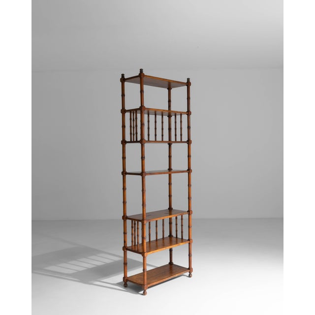This 20th century French faux bamboo étagère offers a refined blend of decorative charm and practical display. Crafted to...