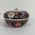 Beautiful small lidded Imari bowl. Hand painted in traditional Imari colors of blue, red, gold. The top of the lid has a...