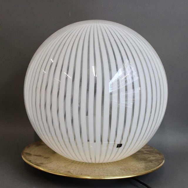 A large 1970s italian murano glass globe table lamp . Modernist and elegant, this blown murano table lamp provides a...