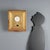Carved and gilded wooden wall clock with embossed decorations. Enamelled metal dial with Roman numerals, the pendulum...