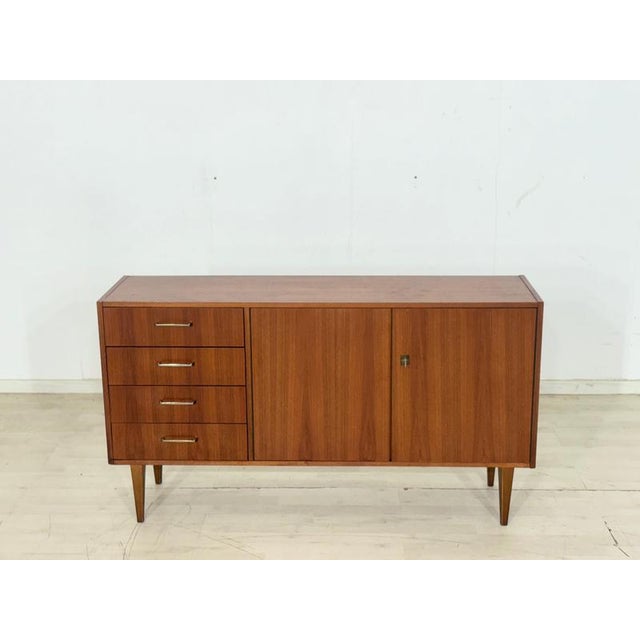 For sale is this exquisite vintage sideboard in the timeless mid-century style of the 1960s. It impresses with its elegant...