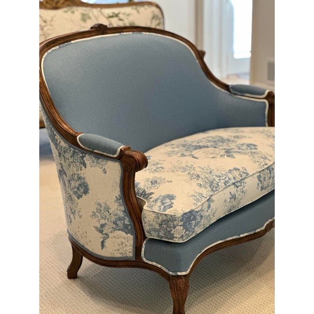 A beautifully reimagined French Louis XV–style settee with coordinating antique footstool, newly renovated and...