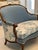 A beautifully reimagined French Louis XV–style settee with coordinating antique footstool, newly renovated and...