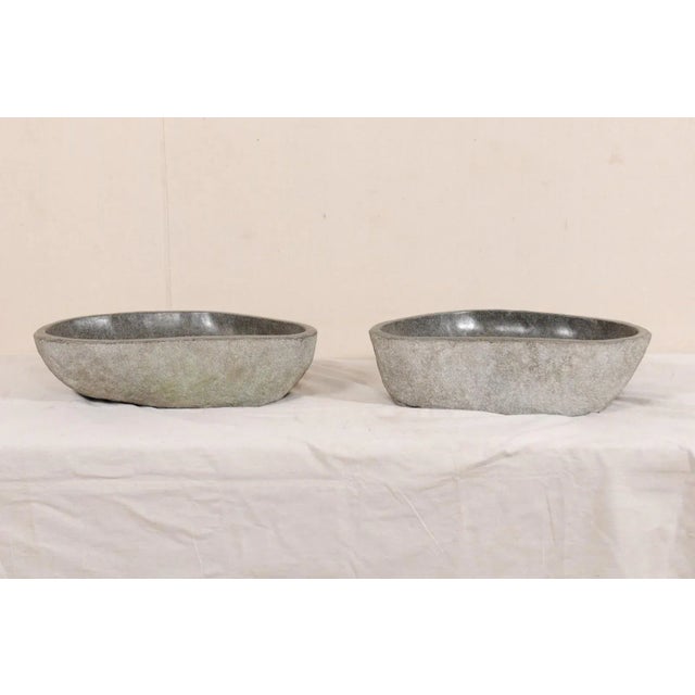 A pair of river rock wash basins. This pair of sinks have each been carved from a single, natural river rock boulder. Each...