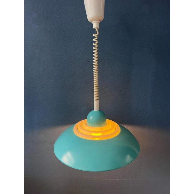Rare blue UFO-shaped pendant lamp designed by Knud Christensen, showcasing the sleek, futuristic aesthetics of...