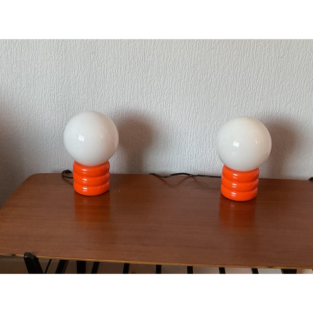 A pair of Italian 1970s Orange and white Murano table lamps. These lamps have a Space- Age style, Opaline white glass...
