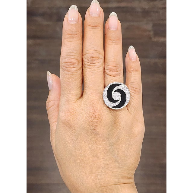A striking cocktail ring featuring a harmonious swirl design. The centerpiece has 41 natural 1.00-carat round diamonds,...