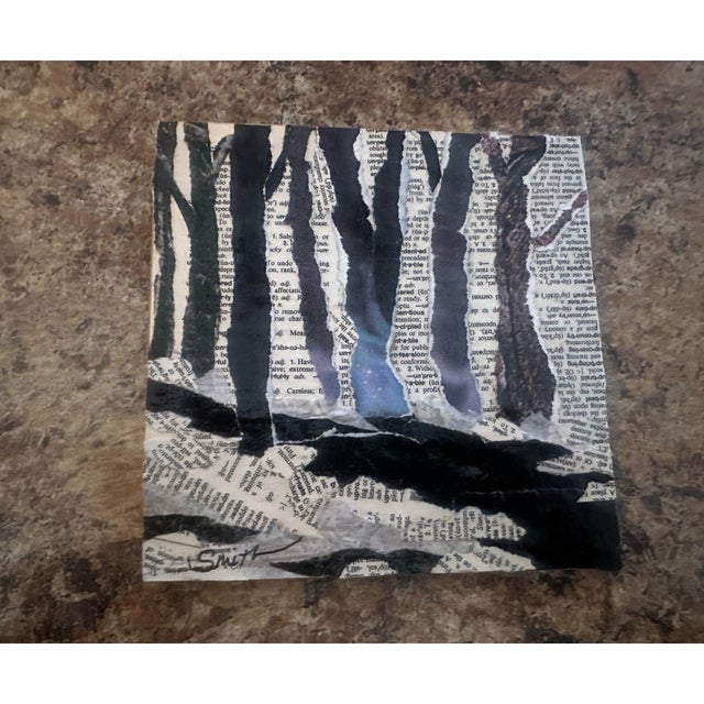 An evocative black-and-white collage constructed from torn book pages and hand-painted paper suggests tall tree trunks...