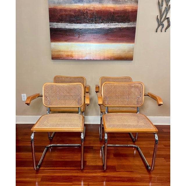 Set of four cantilevered chrome plated steel and cane Cesca chairs originally designed by Marcel Breuer. Arms and chrome...