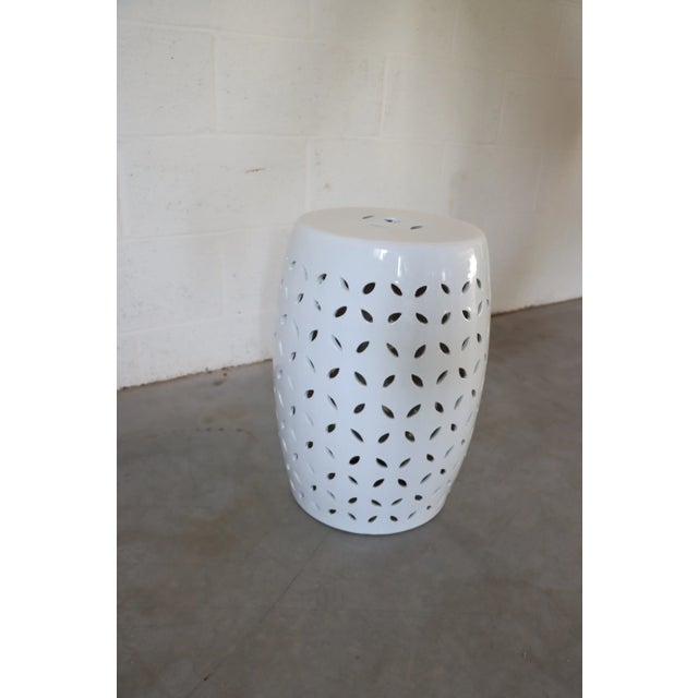 White garden stool with tessellated design.