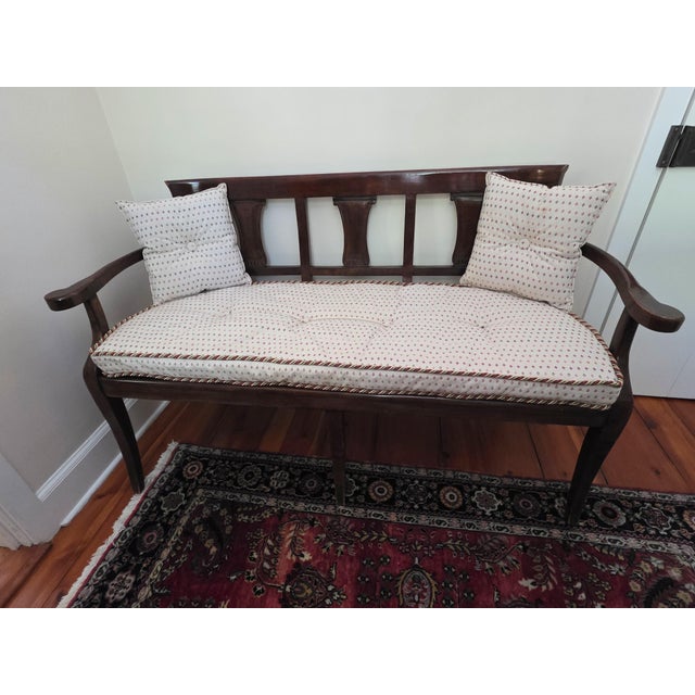 Traditional Biedermeier styled caned seat bench with three vertical decorative carved wood splats. Bench is styled...