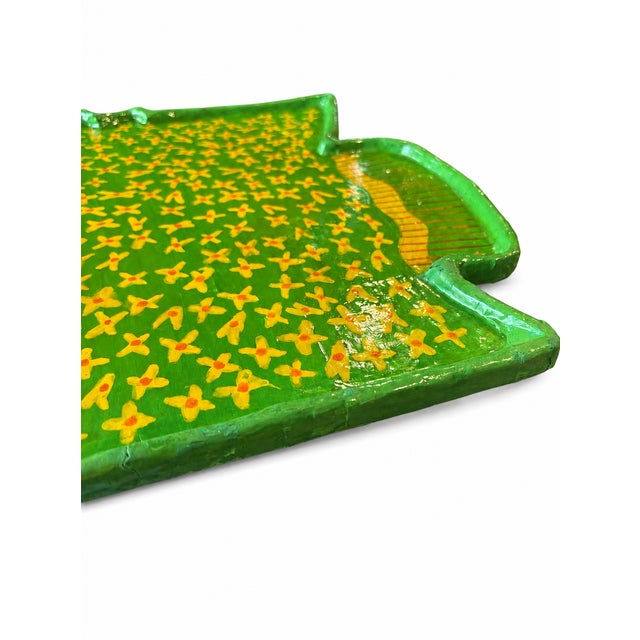 Likely handcrafted, the tray has a textured papier-mâché or pulp-composition surface with visible hand-painted details...