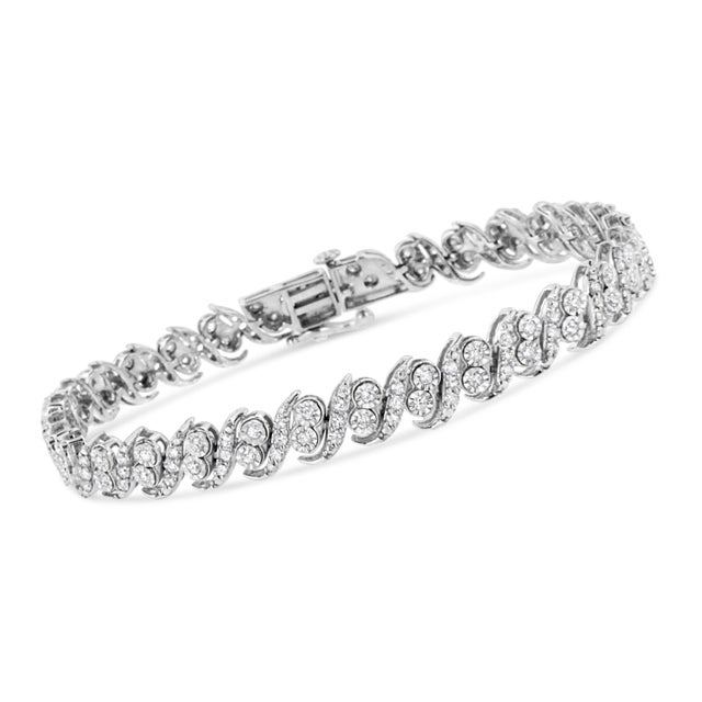 Glamorous yet timeless, this beautiful tennis bracelet has a unique pattern of alternating studded silver "s" links and...