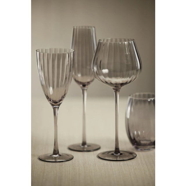 Crafted of beautifully textured glass, the colored glass set features a streamlined design with a pop of color. Raise a...