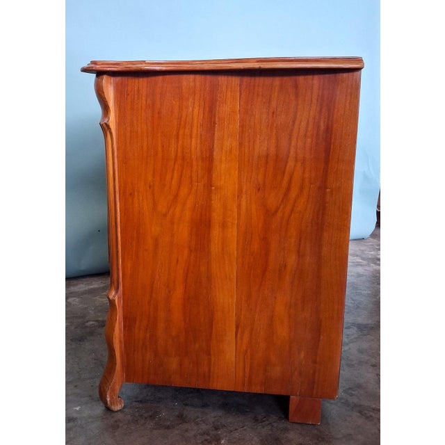 Elegant antique Biedermeier chest of drawers from France with beautiful cherry veneer and classic three-drawer layout. The...