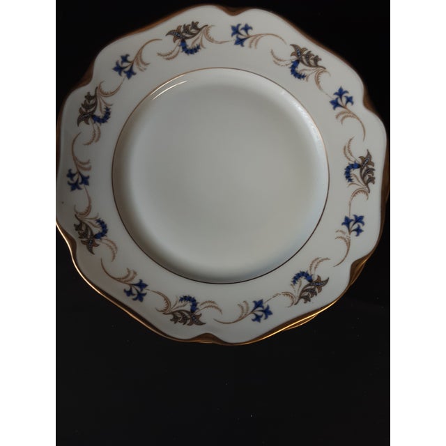 Set of 6 Vintage KPM dinner plates trimmed in gold with design in blue and gold. 30 total available