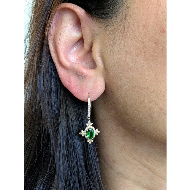 Let your ears do the talking! These playful tsavorite dangle earrings bring bold green energy, earth mined diamond...