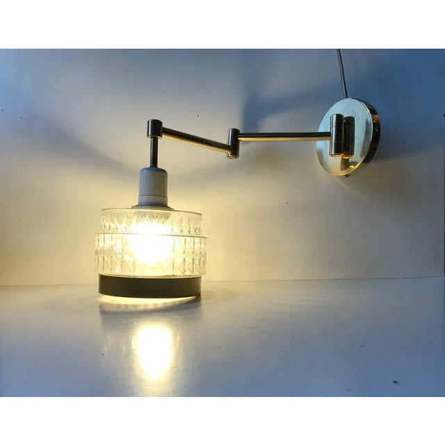 Up or down wall light made in Scandinavia in a style reminiscent of Stilnovo and the french modernist movement. Its...