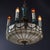 An antique chandelier from circa 1920, embodying a blend of Classical and Arts & Crafts design aesthetics. It features a...