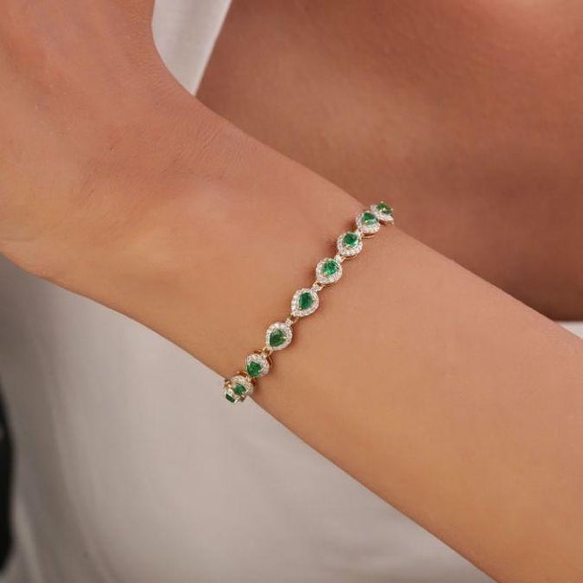 This statement tennis bracelet features 2.68 ct of natural pear-cut emeralds, set in 14k yellow gold. The emeralds measure...