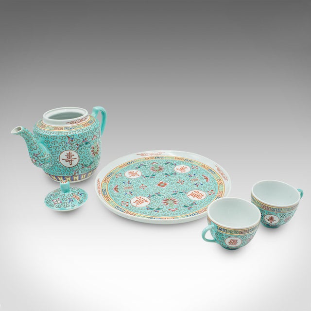 This is a contemporary Mun Shou Longevity tea set. A Chinese, ceramic teapot and teacup service in Famille Rose taste....