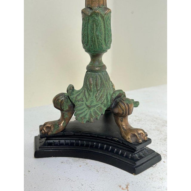 A superb 19th-century Italian gilt bronze and patinated brass candlestick in the neoclassical style, finely cast with...