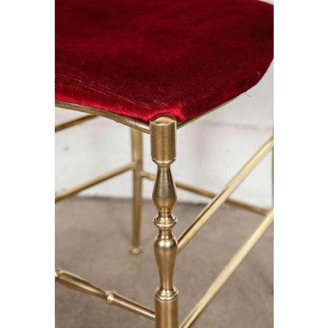Pair of polished brass high back side chairs by Chiavari. A wonderful handcrafted pair of polished brass side chairs with...
